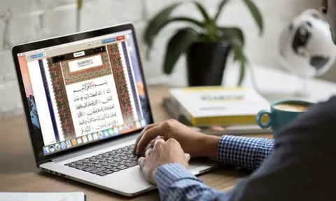 Student reading digital Holy Quran on a laptop for online Quran classes
